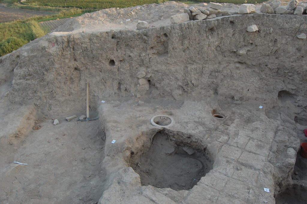 Storage vessels embedded into the floor of the Sasanian building level.